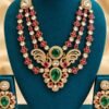Mayur kundan three-strand necklace and earrings displayed on a teal stand