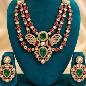Mayur kundan three-strand necklace with emerald-toned peacock centrepiece and matching earrings on a teal velvet stand