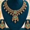 Mint kundan necklace and earrings on a teal velvet stand