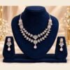 opulence-design14-1-600x900 Blush pink AD necklace and earrings on a navy stand, wider view