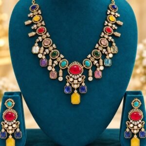 opulence-design2-main-600x900 Navratna-colour stone necklace with red oval centre, yellow drop and matching earrings on a teal stand