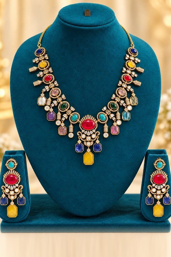 opulence-design2-main-600x900 Navratna-colour stone necklace with red oval centre, yellow drop and matching earrings on a teal stand