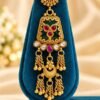 opulence-design3-2-600x900 Close-up of one earring with floral stud, green panel and gold-tone tassels