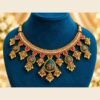 Close-up of the choker with pearl-look bead row, emerald-green panels and jhumka drops