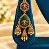 One emerald-green meena jhumka earring with pink floral motif and three jhumkas