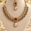 Kundan necklace and maang tikka on a cream velvet stand