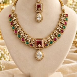 Kundan-style necklace with square ruby-toned centre and clear teardrop, with matching maang tikka