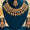 Pastel stone necklace, maang tikka and earrings on a teal velvet stand